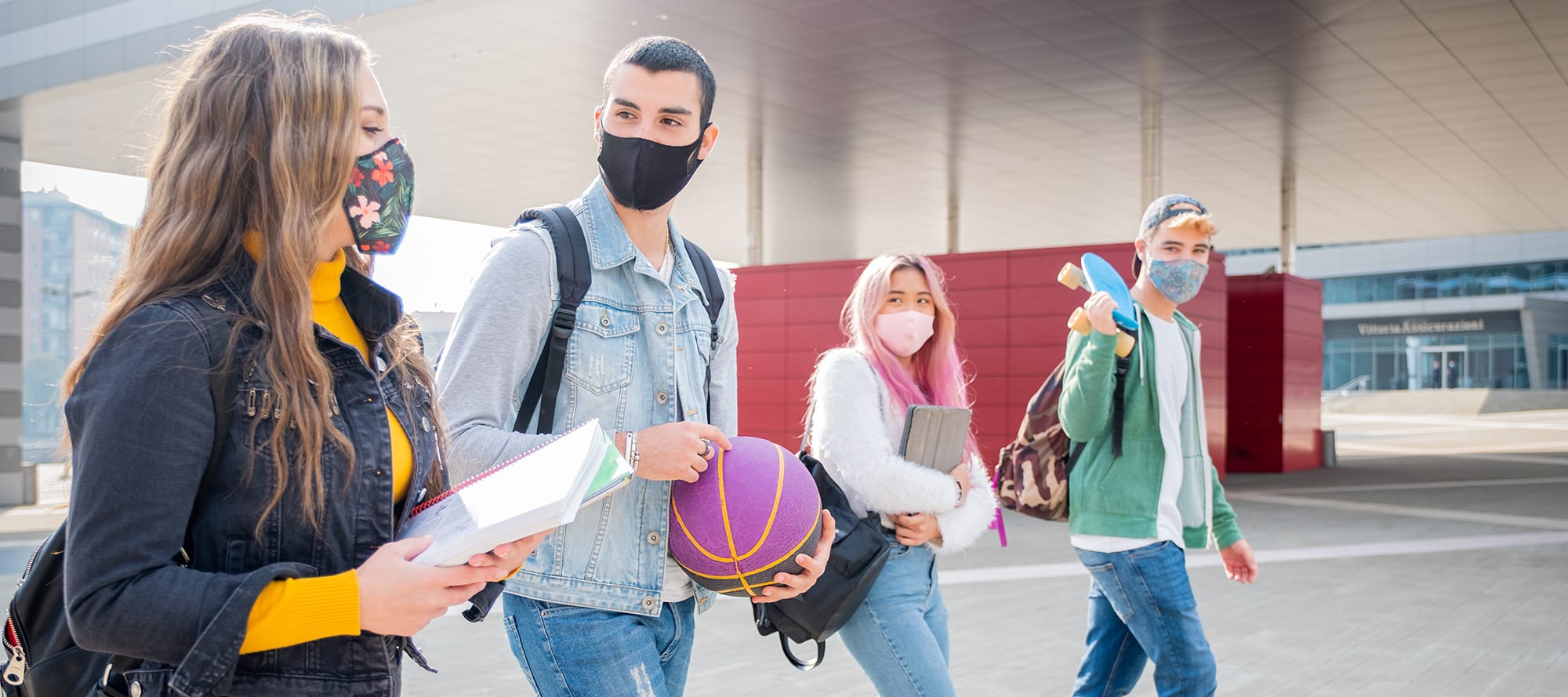 College Students walking together with medical masks on