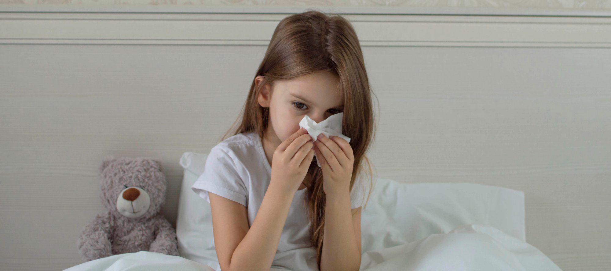 child blowing her nose