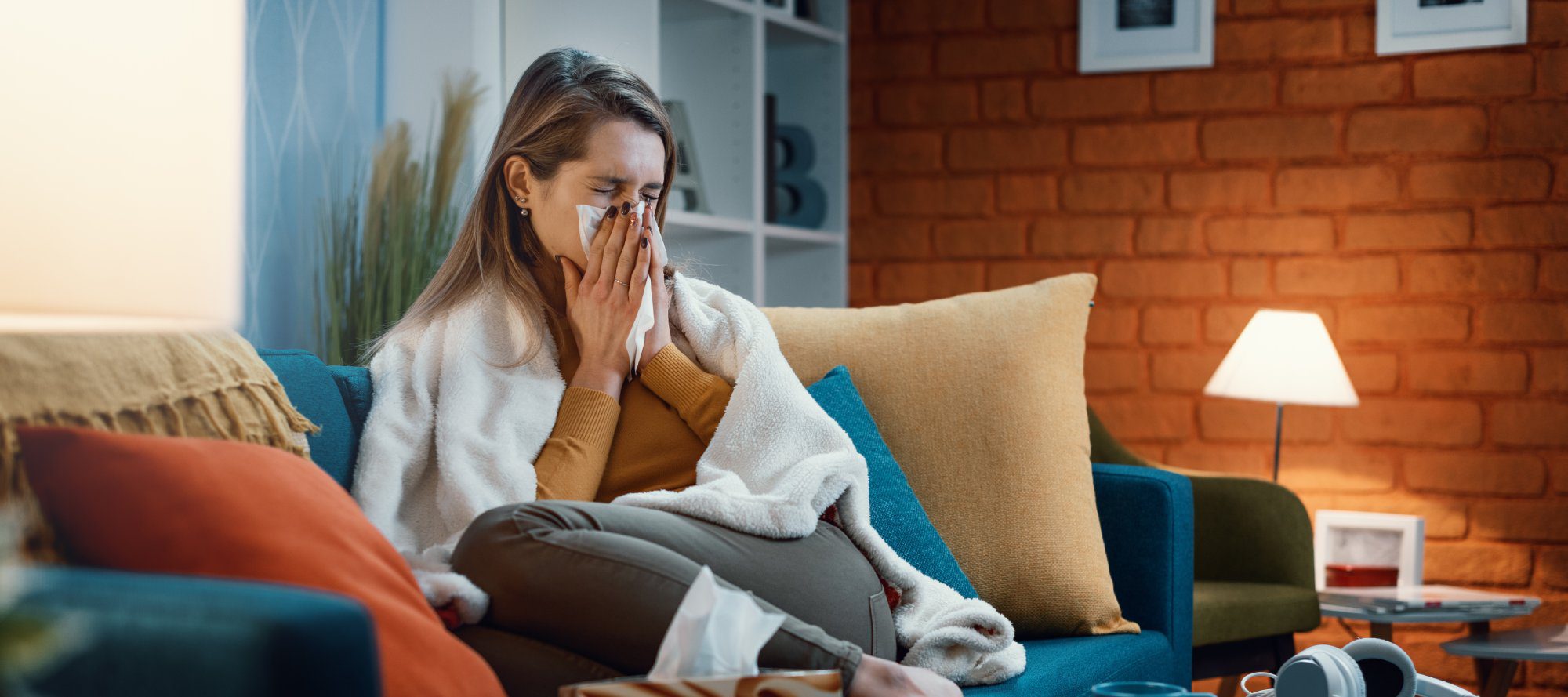 Woman with cold and flu blowing her nose