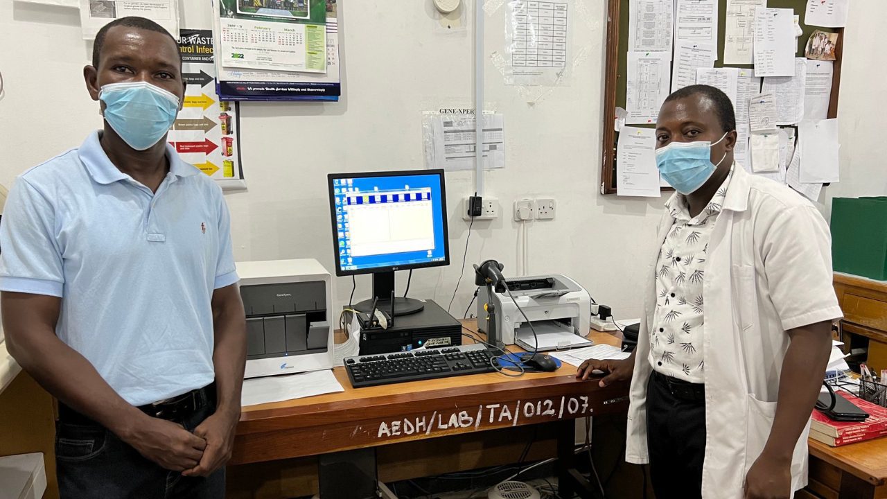 Ada hospital employees in lab by computer