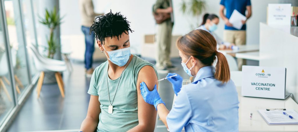 Healthcare worker giving a Covid-19 vaccine shot