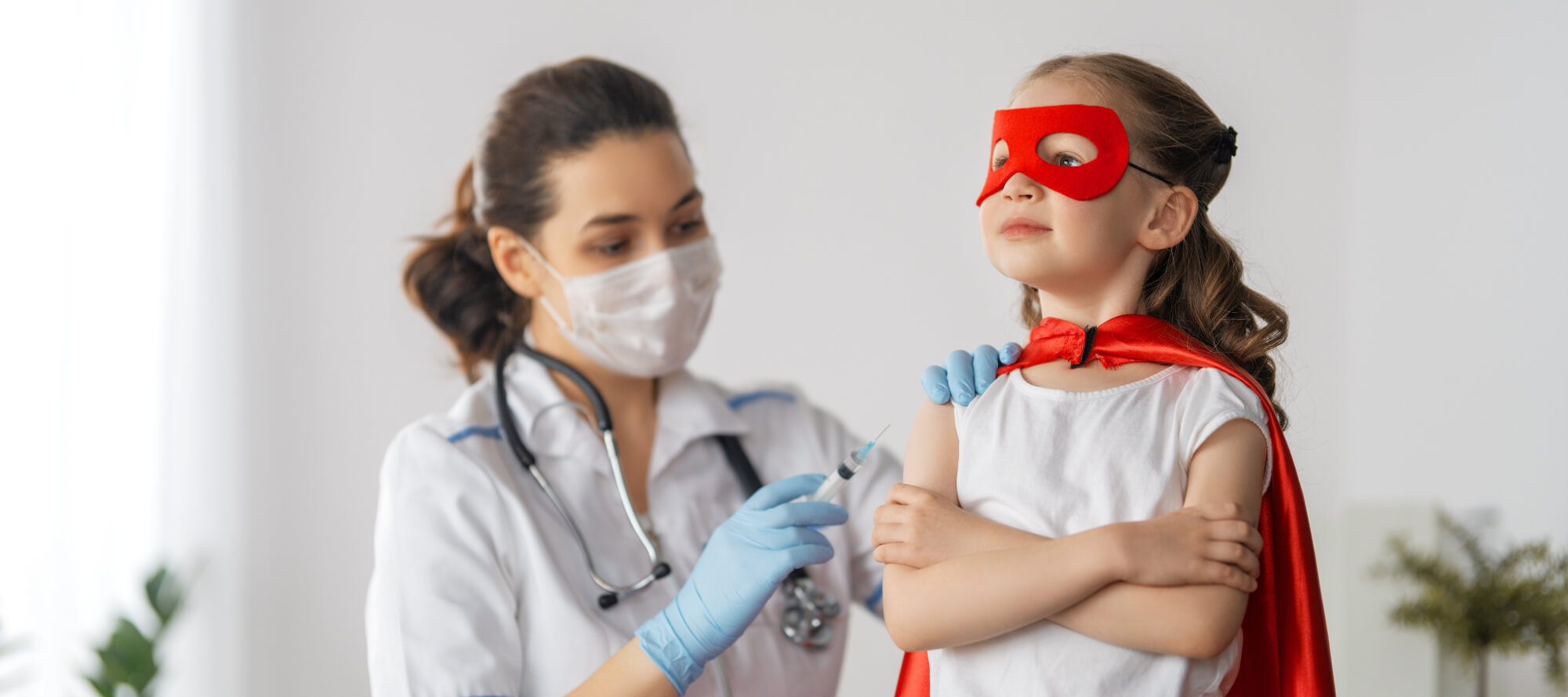 A doctor carefully a vaccine to a young child in a clinic.