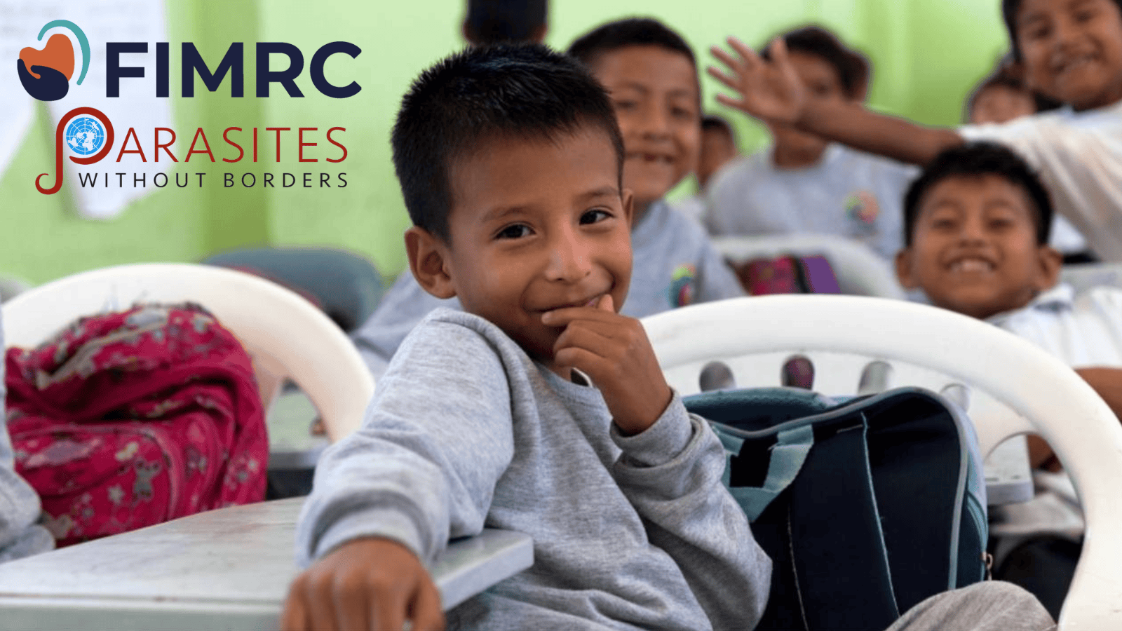 May Donations Image of child smiling in classroom setting