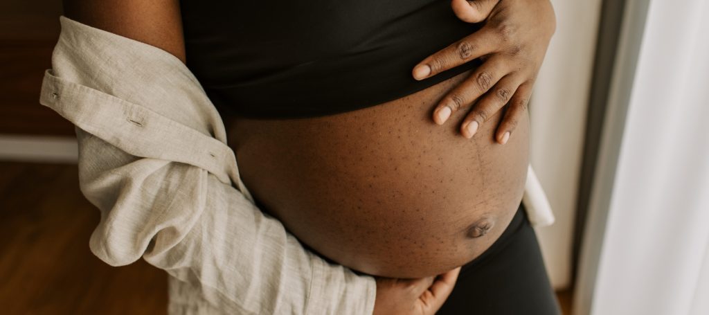 Pregnant woman holding her stomach